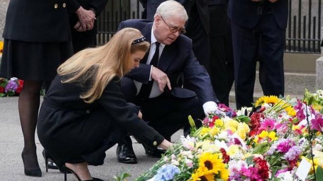 Princess Eugenie, Peter Phillips, Vice Admiral Sir Timothy Laurence, Zara Tindall, Princess Beatrice and Prince Andrew, Duke of York view the messages and floral tributes left by members of the public, following the passing of Britain's Queen Elizabeth, in Balmoral, Scotland