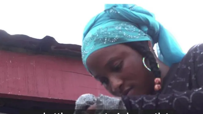 Woman wey dey look inside sack