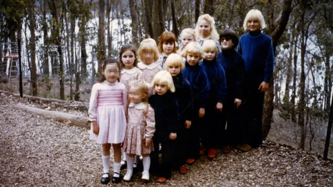 Children lined up in the compound of The Family