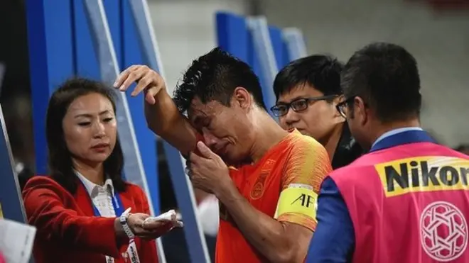 China's midfielder Zhi Zheng (C) reacts following their defeat during the 2019 AFC Asian Cup quarter-final football match between China and Iran at the Mohammed Bin Zayed Stadium Stadium in Abu Dhabi on January 24, 2019. (Photo by Roslan RAHMAN / AFP) (Photo credit shoul