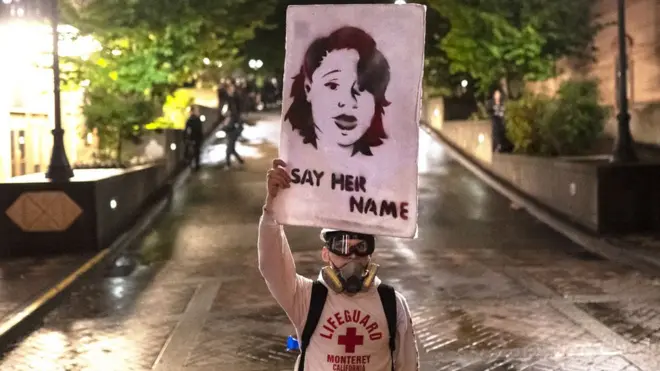 Protester holds picture of Breonna Taylor
