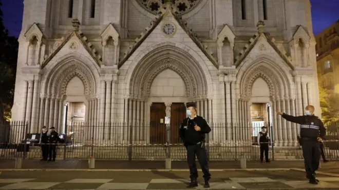 Armed French police guard outside the Notre-Dame basilica in Nice, France. Photo: 29 October 2020