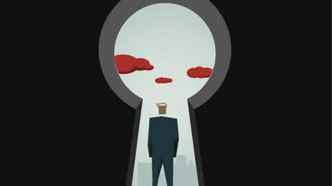 Man looking through giant keyhole