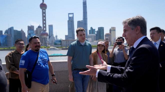 U.S. Secretary of State Antony Blinken speaks with U.S. tourists as he walks in a waterfront area called The Bund, in Shanghai, China April 25,