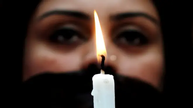 క్యాండిల్ పట్టుకున్న యువతి