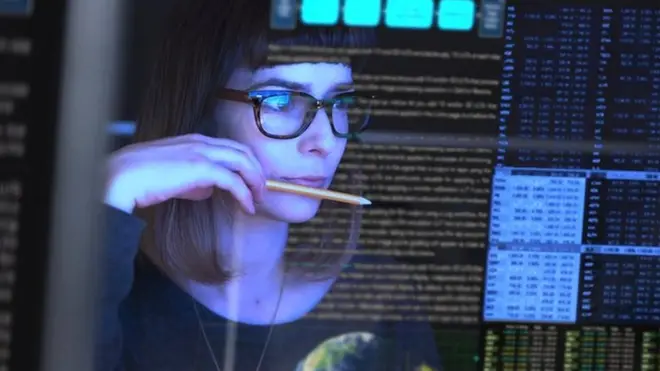 డేటాను పరిశీలిస్తున్న మహిళ