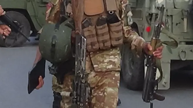 An Afghan soldier holds a gun