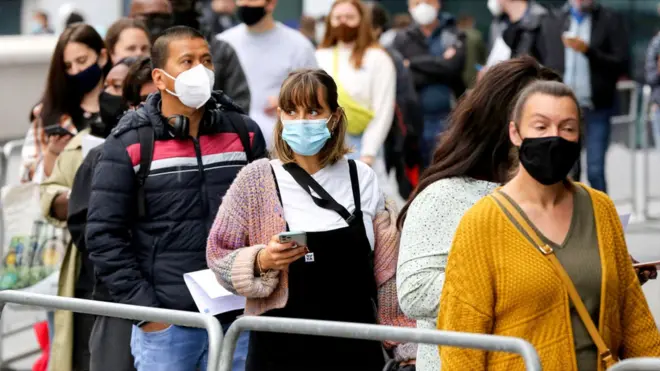 People queue for a dose of the Pfizer Covid-19 vaccine at Tottenham Hotspur Stadium, London, on 20 June 2021