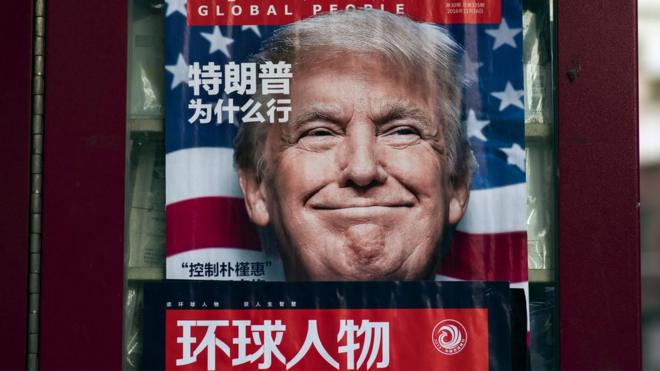 An advertisement for a magazine featuring US President-elect Donald Trump on the cover at a news stand in Shanghai, December 2016.