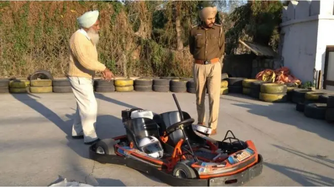 The woman was wearing a helmet and had her hair tied while riding the go-kart