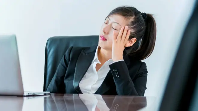 Woman falling asleep in meeting