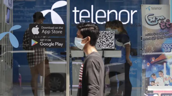 Man walks past Telenor showroom in Yangon, Myanmar, on 4 February 2021