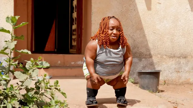 A woman stands in front of a door