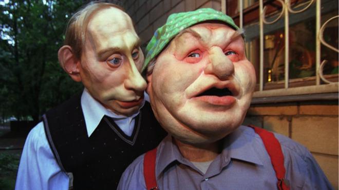 Puppet of Russian President Vladimir Putin, left, whispers a word to Moscow's mayor Yuri Luzhkov, June 29, 2000