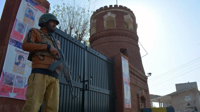 A Pakistani security official guards a gate