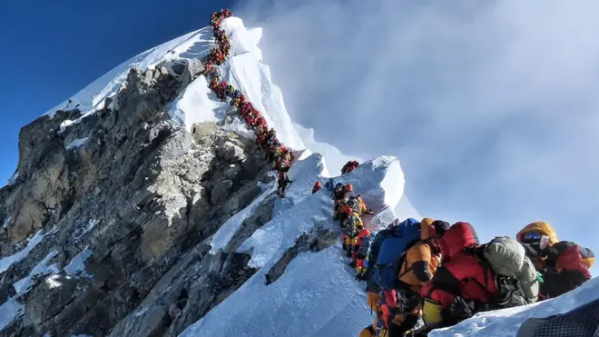 A photo from Nirmal Purja's Project Possible expedition shows a long queue of mountain climbers lining up to stand at the summit of Mount Everest