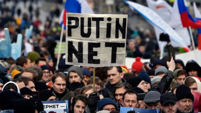 A protester holds a placard reading "Putin - No!" during an opposition rally in central Moscow, on 10 March