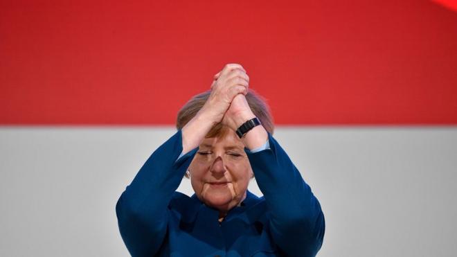 German Chancellor and leader of the Christian Democratic Union (CDU) Angela Merkel acknowledges the applause after delivering her speech at a party congress of Germany"s conservative Christian Democratic Union (CDU) party on December 7, 2018 at a fair hall in Hamburg, northern Germany. - German Chancellor Angela Merkel will hand off leadership of her party after nearly two decades at the helm, with the race wide open between a loyal deputy and a longtime rival. (Photo by John MACDOUGALL / AFP)JOHN MACDOUGALL/AFP/Getty Images