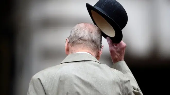 Britain's Prince Philip pictured from behind as he doffs his hat on 2 August, 2017.