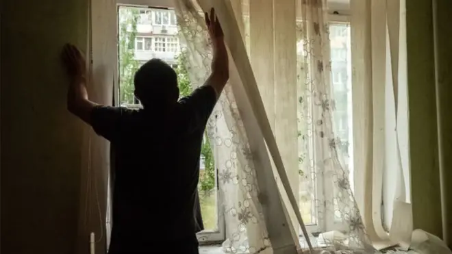 A resident inside his apartment following shelling in the centre of Mykolaiv, Ukraine