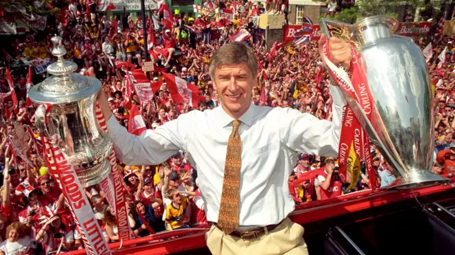 Arsene Wenger with the FA Cup and Premier League trophy