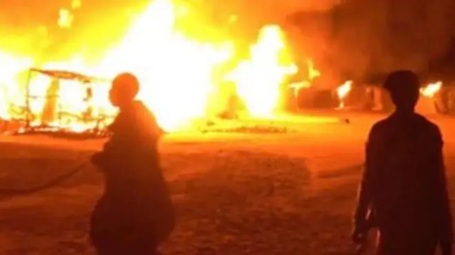 Two people at an explosion site