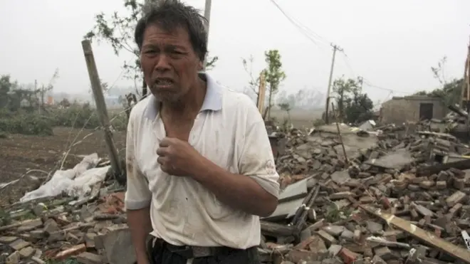 A villager stands near destroyed houses in China's Jiangsu province. Photo: 23 June 2016