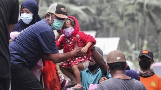 Officials evacuate people from Kamar Kajang village in East Java