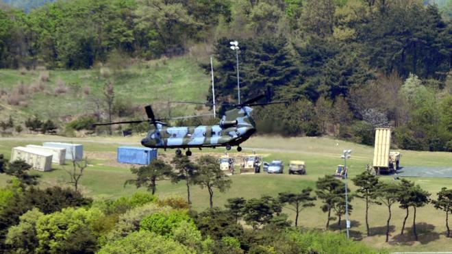 A helicopter installs Terminal High Altitude Area Defense (THAAD) interceptor (R) in Seongju, South Korea (26 April 2017)