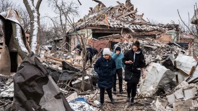 Women dey waka among destroyed residential buildings by shelling, inside Zhytomyr for Ukraine.