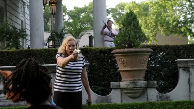 Patricia McCloskey and her husband Mark McCloskey draw their firearms on protesters in St Louis, Missouri, on 28 June 2020.