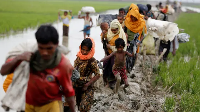 Rohingya refugees walk on the muddy path after crossing the Bangladesh-Myanmar border in Teknaf, Bangladesh, 3 September 2017