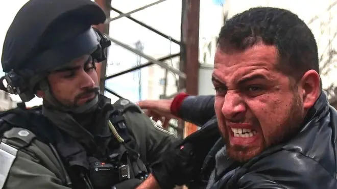 An Israeli soldier quarrels with a Palestinian demonstrator, during a Land Day demonstration in the Palestinian town of Huwara in the occupied West Bank, commemorating the events of 30 March1976, when Israeli troops shot and killed six people among Arab Israelis and Palestinians protesting against land confiscations