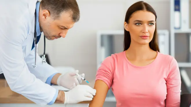 Doctor vaccinating a woman