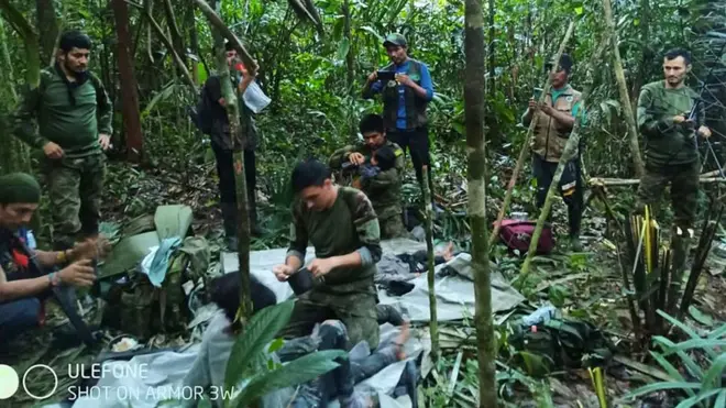 Colombian soldiers tend to the four children shortly after they were found