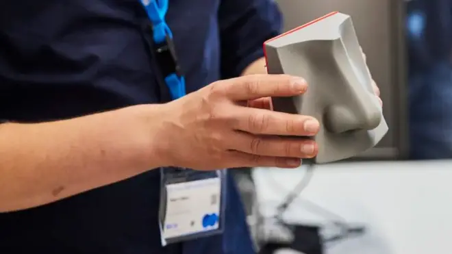 A man holding an ATT e-nose