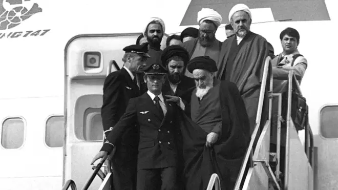 Ayatollah Khomeini returns to Tehran after 15 years of exile, accompanied by close allies