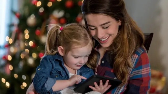 Mum and daughter read an e-book