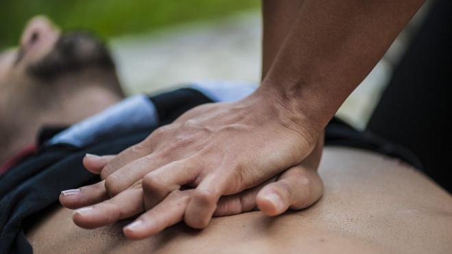 Man giving chest compressions or CPR