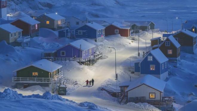 An snow-covered view of a street in the fishing village Upernavik in Greenland