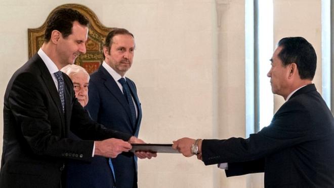 President Bashar al-Assad (L) receiving diplomatic credentials from North Korea's newly-appointed ambassador to Damascus (R), Mun Jong-nam