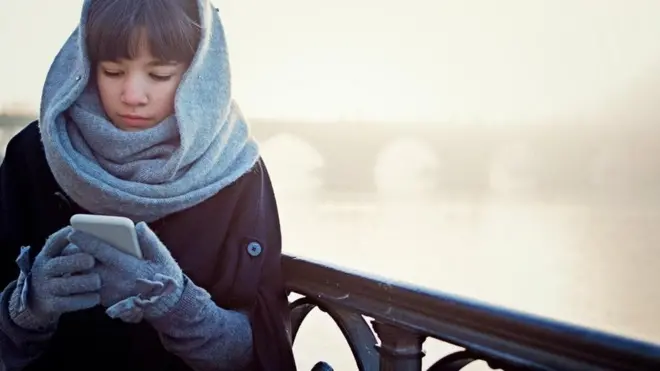 woman holding a mobile phone