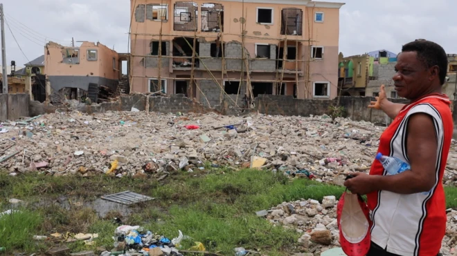 Abule Ado fire victim Joseph Ojukwu point to im house wey destroy