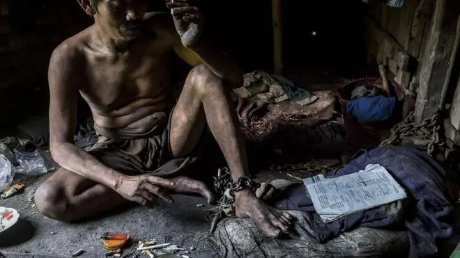 Foto dari Maret 2016 ini memperlihatkan Judi, 45, yang sudah dipasung selama 16 tahun oleh orang tuanya di rumah mereka di Jambon, Ponorogo, Jawa Timur, karena mengalami gangguan mental.