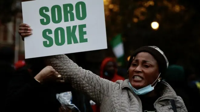 End SARS protester hold placard