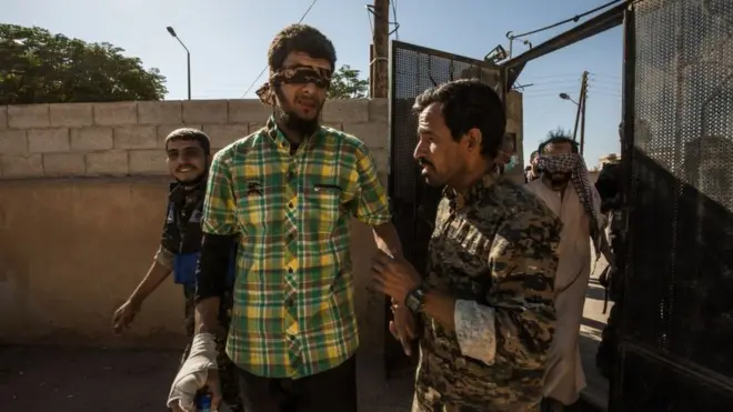 A suspected IS fighter seen being taken for interrogation by SDF fighters in Raqqa in October 2017