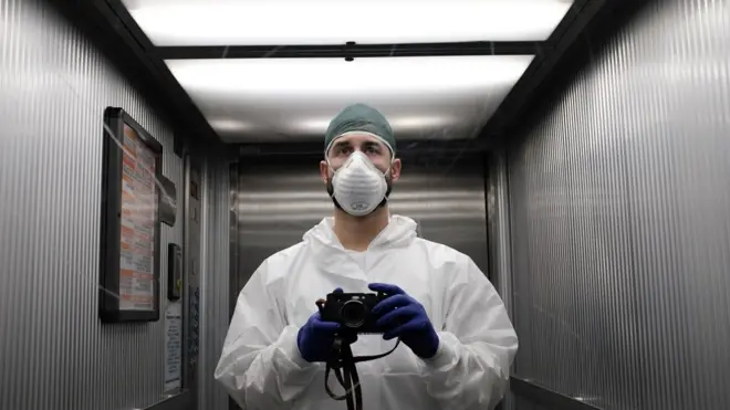 A member of hospital staff with a camera