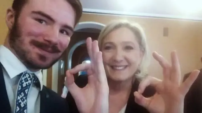 Ruuben Kaalep, left, and Marine Le Pen, right, make the OK hand symbol using the thumb and forefinger to close a circle while the other three fingers naturally rest vertically, as both smile at the camera
