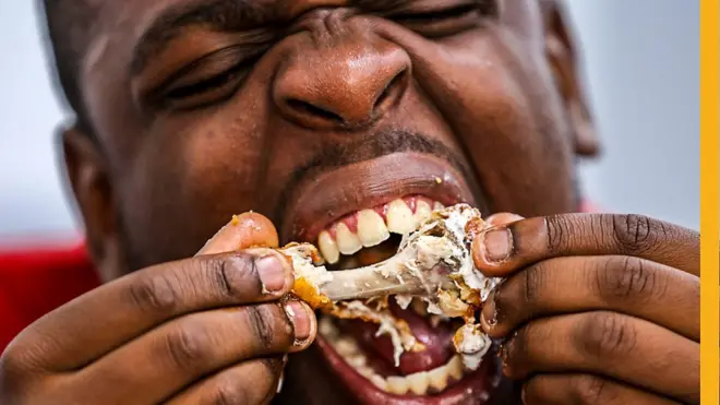 Man eating chicken