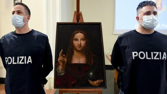 Image shows two police officers stood next to the recovered painting